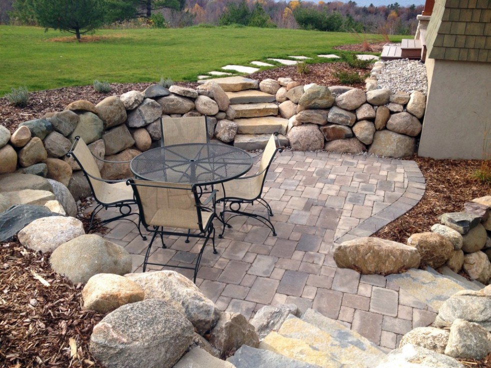 custom patio with large stone landscaping and stairs